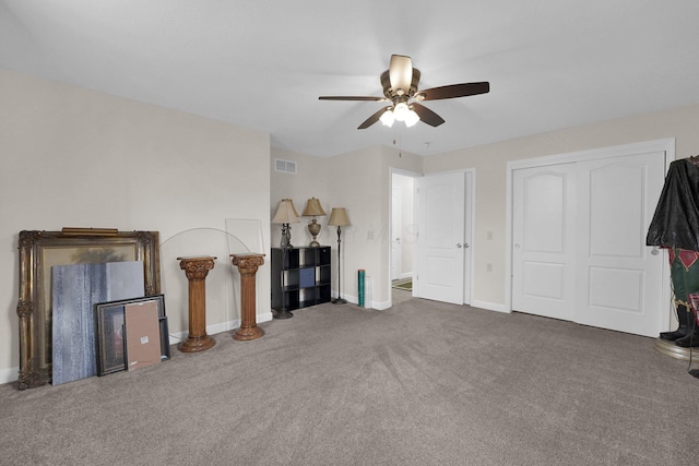 unfurnished living room with carpet, visible vents, ceiling fan, and baseboards