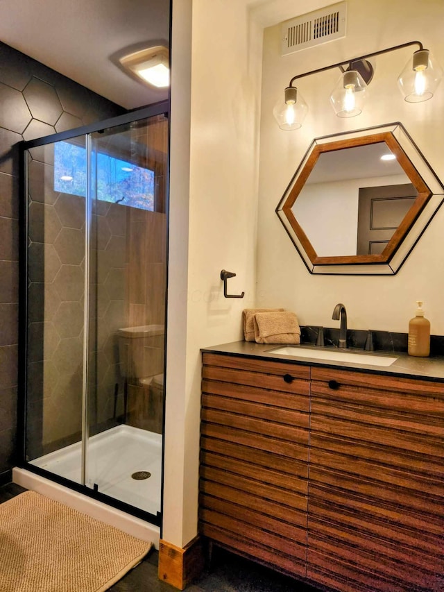 bathroom featuring a shower stall, visible vents, and a sink