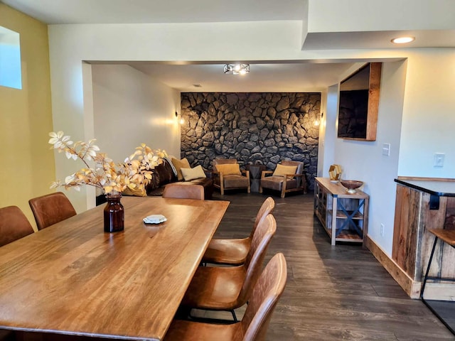 dining space featuring baseboards and dark wood finished floors