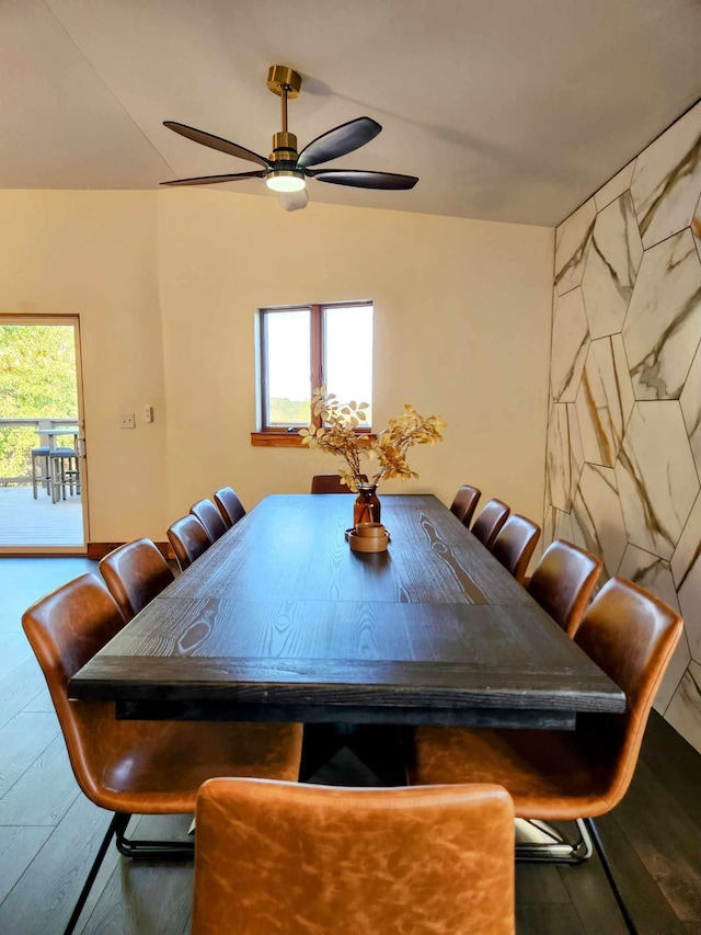 unfurnished dining area featuring a ceiling fan and wood finished floors