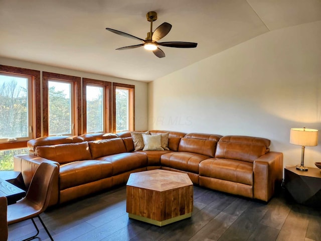 living area with lofted ceiling, ceiling fan, and dark wood finished floors