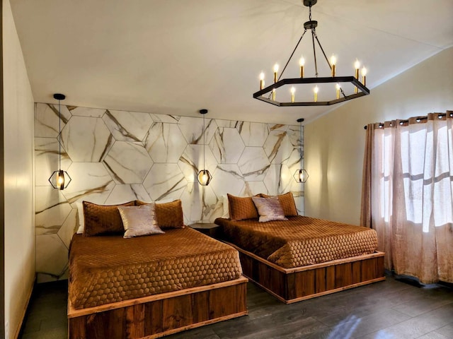 bedroom with vaulted ceiling and wood finished floors