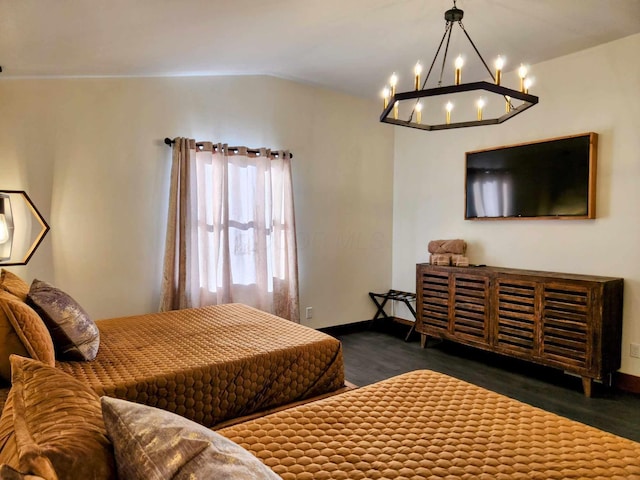 bedroom featuring vaulted ceiling, baseboards, and wood finished floors