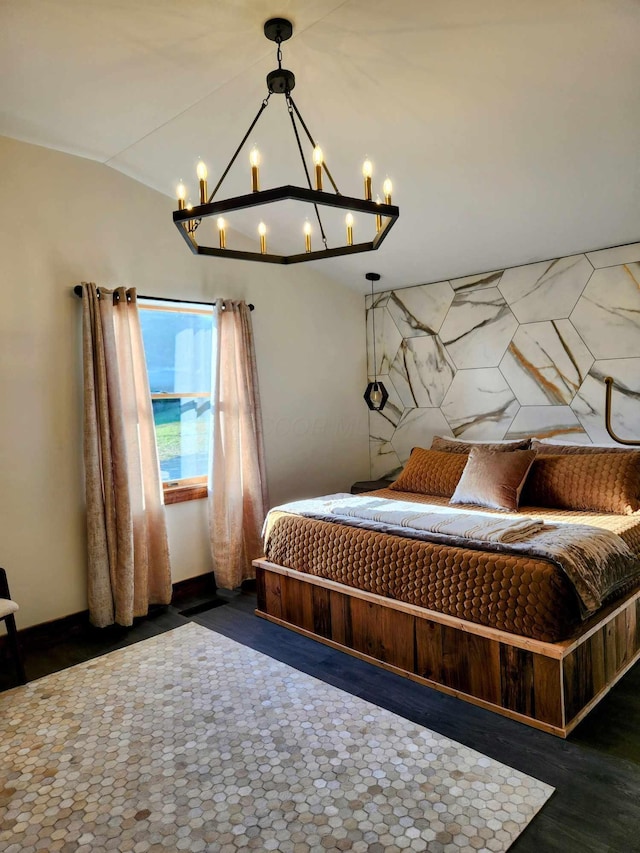 bedroom featuring lofted ceiling and baseboards