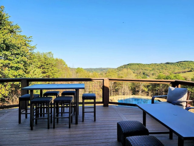 wooden deck with a wooded view