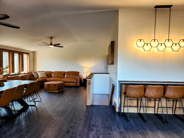 dining space with dark wood-style floors and ceiling fan