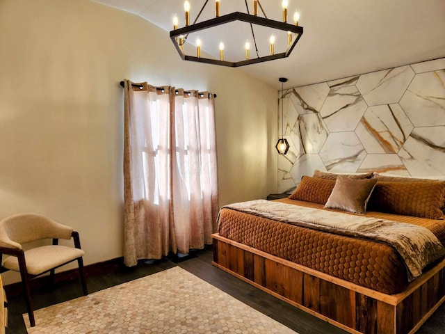 bedroom featuring lofted ceiling and wood finished floors