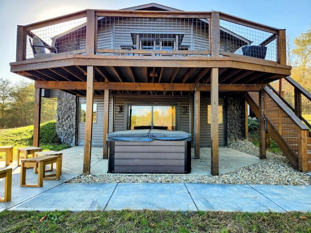 exterior space with a hot tub, stairway, central AC, and a patio