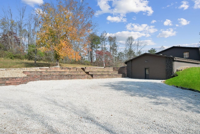 view of yard with driveway and fence