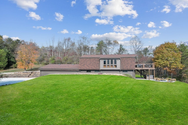 rear view of property with a deck, a yard, a patio, and stairs