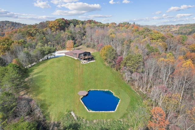 aerial view with a water view and a wooded view