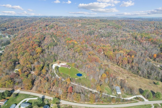 birds eye view of property featuring a view of trees