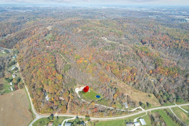 birds eye view of property with a view of trees