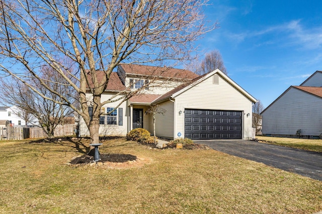 traditional-style home with aphalt driveway, a front yard, fence, and an attached garage