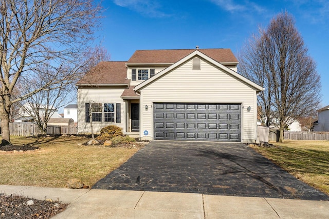 traditional-style house with driveway, a front lawn, and fence