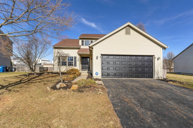 traditional home featuring driveway, a garage, and fence