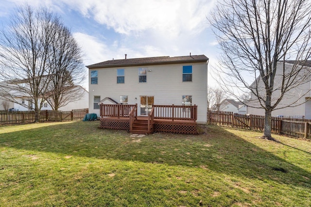 back of property with a yard, a fenced backyard, and a wooden deck