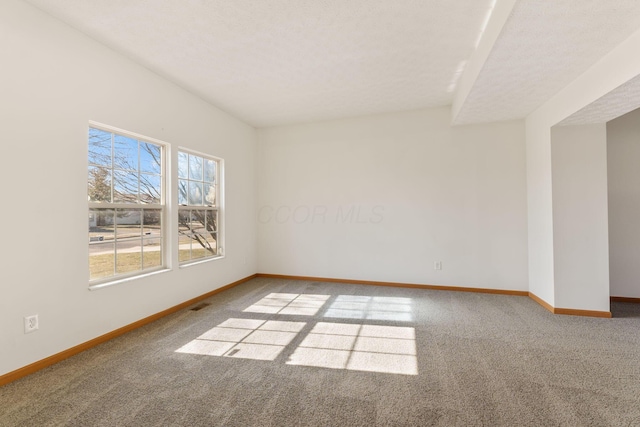 carpeted empty room featuring visible vents and baseboards