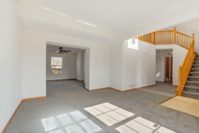 empty room with baseboards, stairs, visible vents, and carpet flooring