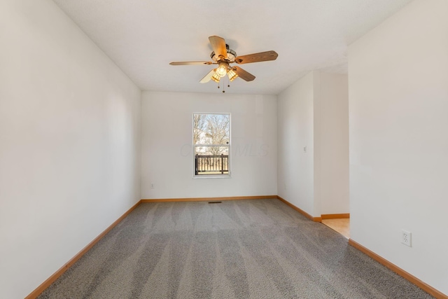 unfurnished room featuring a ceiling fan, carpet flooring, visible vents, and baseboards