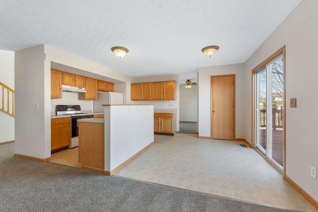 kitchen featuring white appliances, under cabinet range hood, baseboards, and light countertops