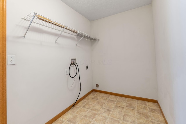 washroom featuring baseboards, laundry area, hookup for a washing machine, and hookup for an electric dryer