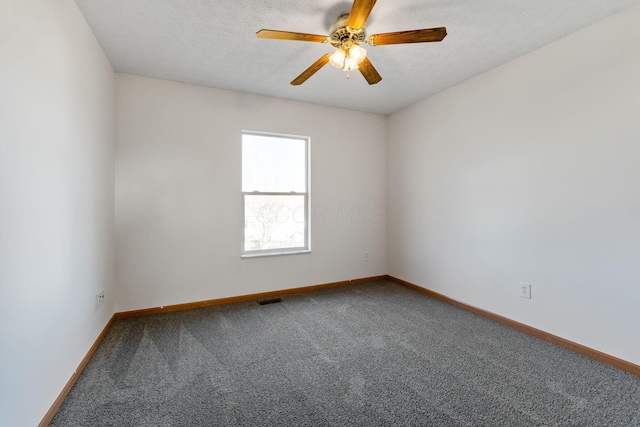 unfurnished room featuring ceiling fan, a textured ceiling, carpet flooring, visible vents, and baseboards