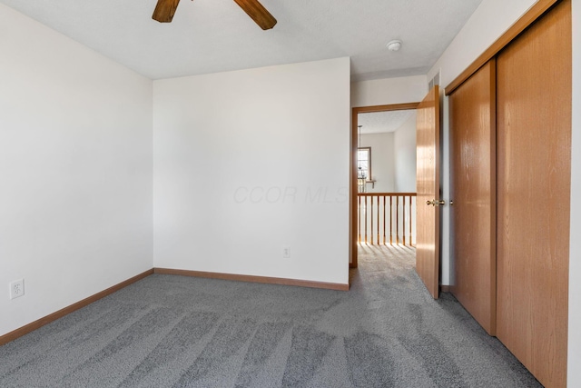 empty room with ceiling fan, baseboards, and carpet flooring