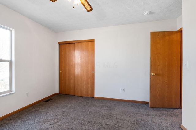 unfurnished bedroom with carpet, a closet, visible vents, and baseboards