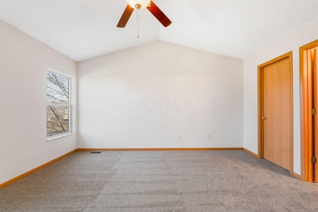 unfurnished bedroom featuring carpet floors, lofted ceiling, baseboards, and a ceiling fan