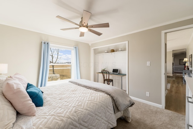 carpeted bedroom featuring a ceiling fan, crown molding, and baseboards