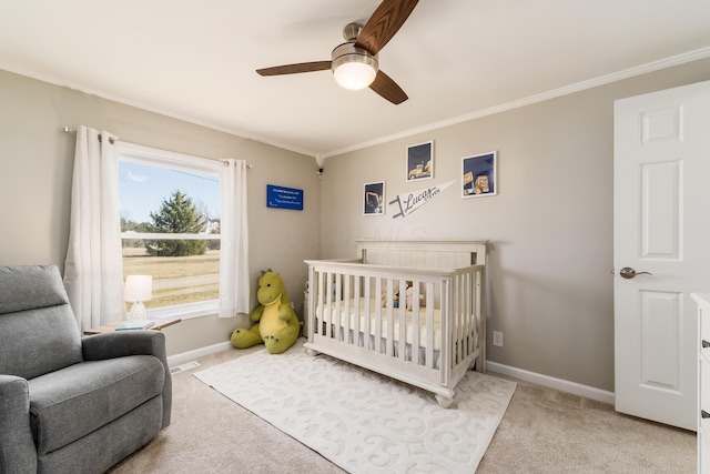 bedroom with crown molding, baseboards, and carpet floors