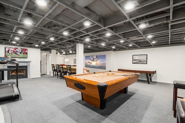 game room with carpet flooring, baseboards, a warm lit fireplace, and billiards