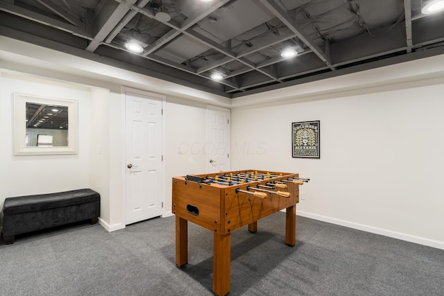 recreation room featuring baseboards and carpet