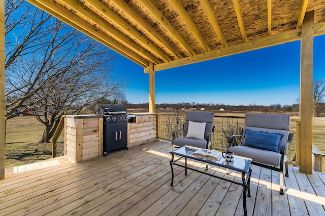 wooden deck featuring a grill