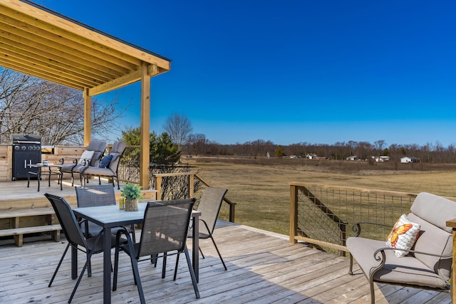 deck featuring outdoor dining area and grilling area