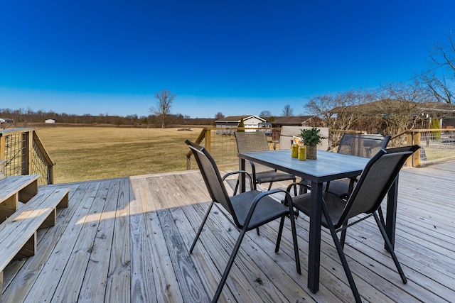 wooden deck with outdoor dining area and a lawn