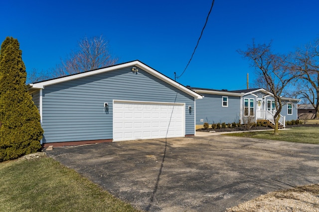 view of home's exterior featuring driveway and a garage