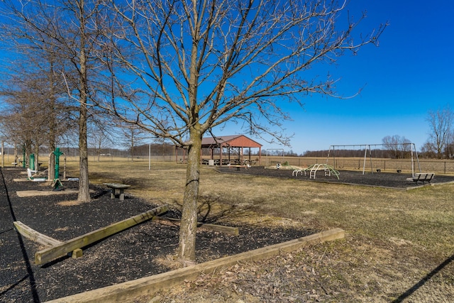 view of yard with a gazebo, fence, and playground community