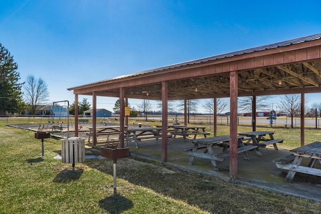 surrounding community with a yard, a carport, and playground community