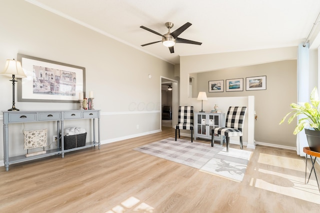 interior space with a ceiling fan, baseboards, lofted ceiling, ornamental molding, and light wood-type flooring