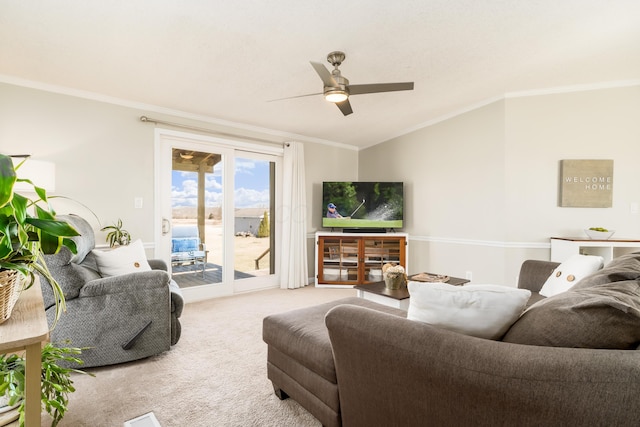 living room with lofted ceiling, a ceiling fan, crown molding, and carpet