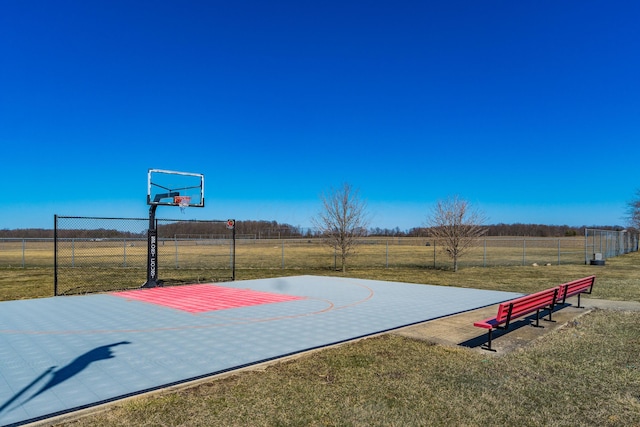 view of basketball court with basketball court, a yard, and fence