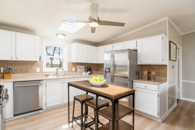 kitchen featuring a sink, appliances with stainless steel finishes, and light countertops