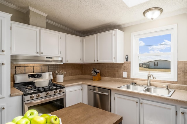 kitchen featuring under cabinet range hood, appliances with stainless steel finishes, light countertops, and a sink