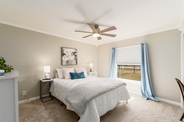 bedroom with crown molding, baseboards, and light carpet