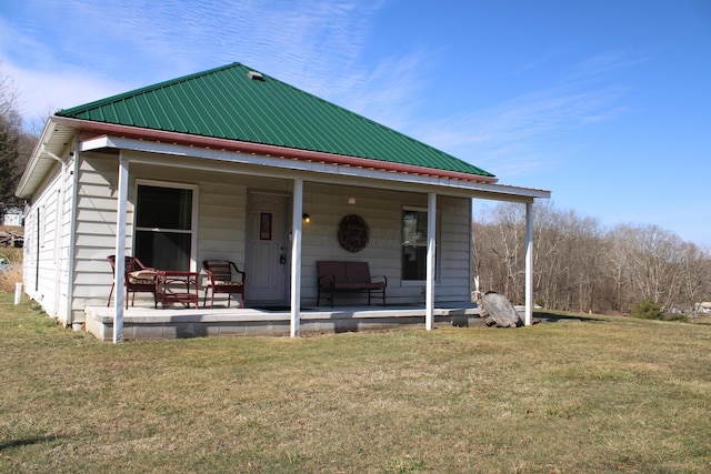 view of front of house with metal roof and a front yard