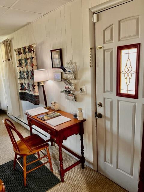 office featuring baseboard heating and carpet flooring