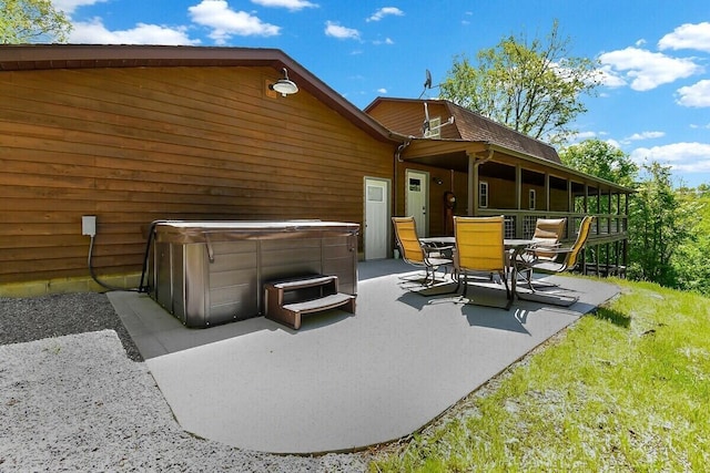 view of patio / terrace with a hot tub and outdoor dining area