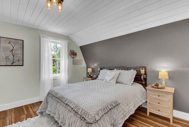 bedroom featuring lofted ceiling, wood ceiling, baseboards, and wood finished floors